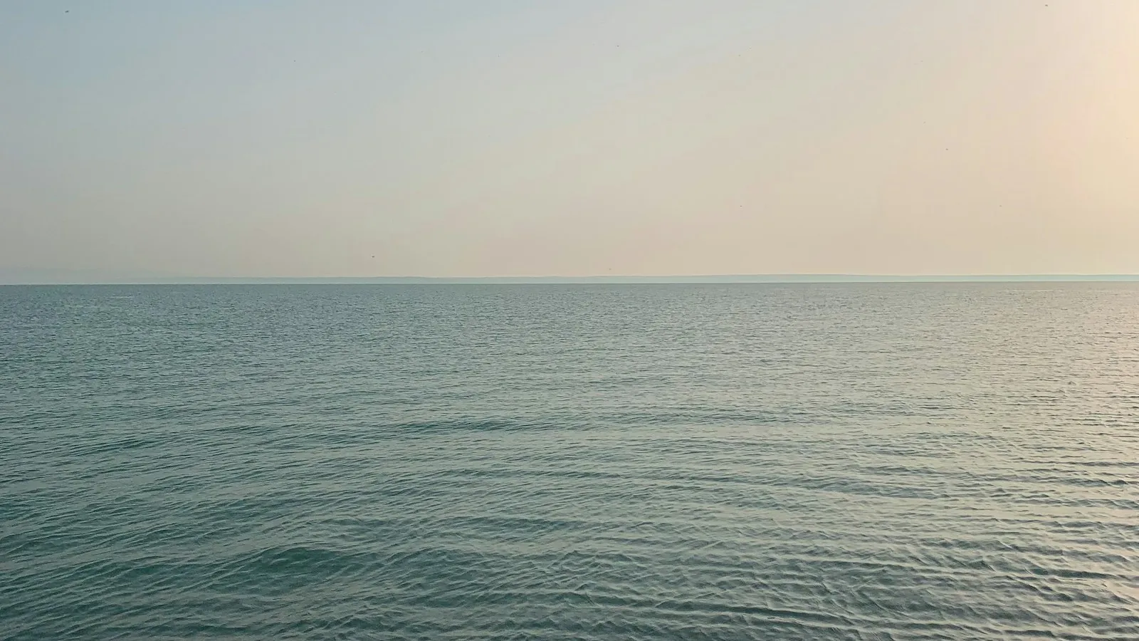 La superficie tranquila del lago Balaton en Siófok bajo un cielo nublado